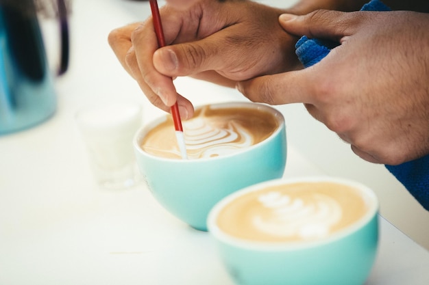 Barista demonstrating brewing techniques in hands-on workshop